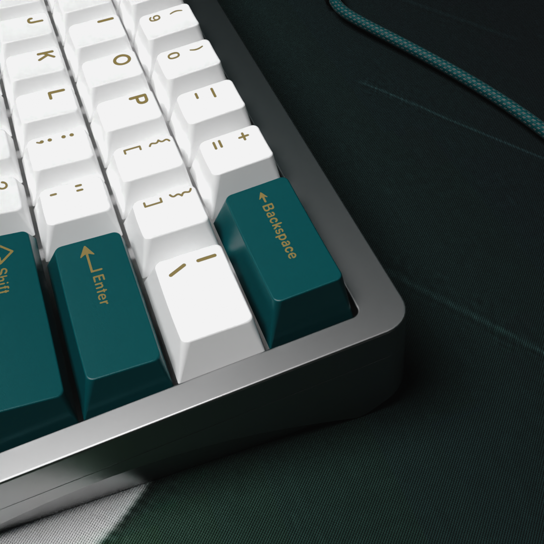 a close up on the far right of our beautiful Zen pearl keycap set, off white keycaps with gold legends and awesome teal accents